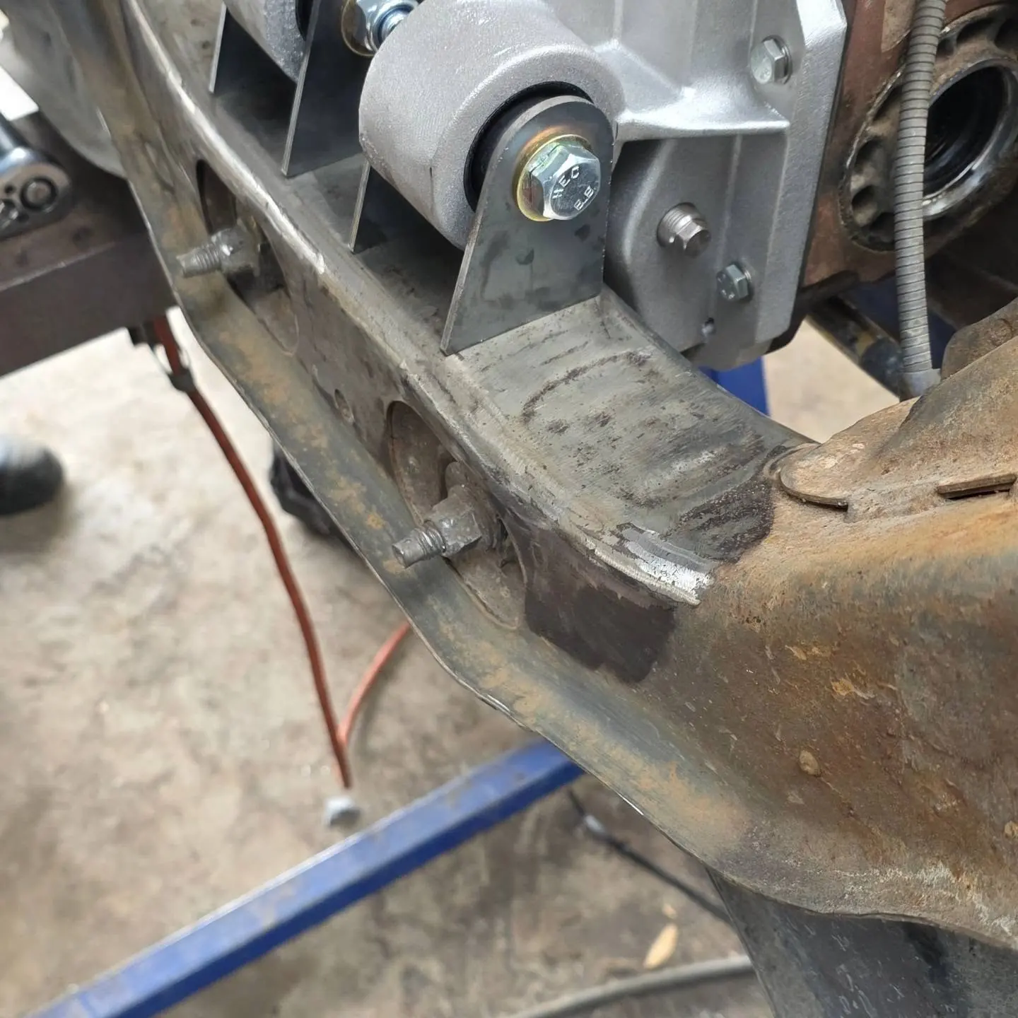 Rear cradle on stands, ground back to bare steel where the new bracket goes