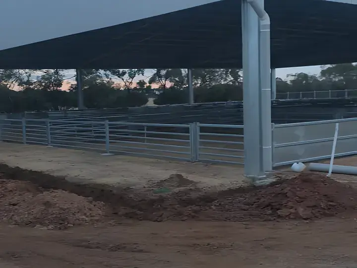 Steel yards under a large steel-framed shed at dusk