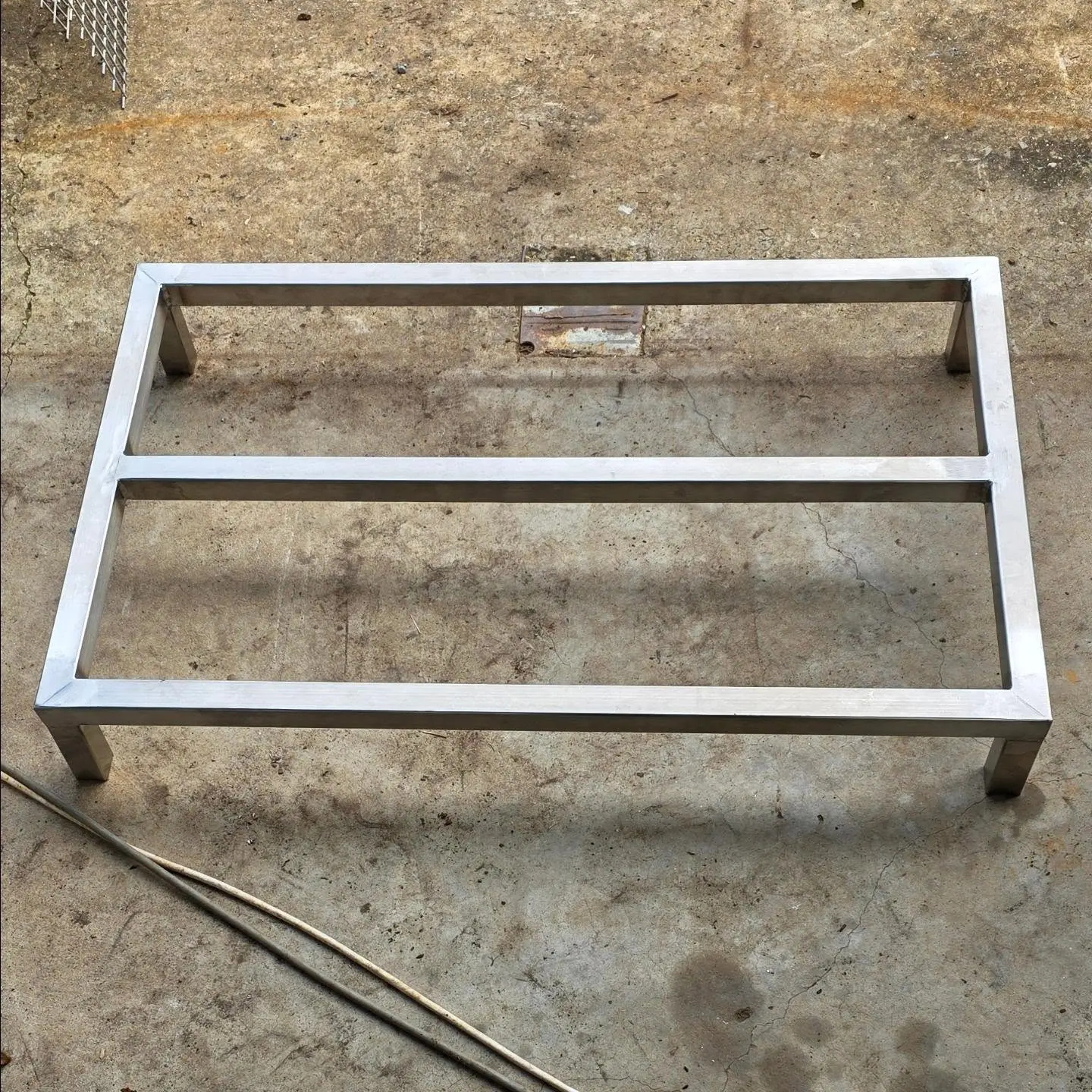 TIG welded stainless steel stand on a workshop floor